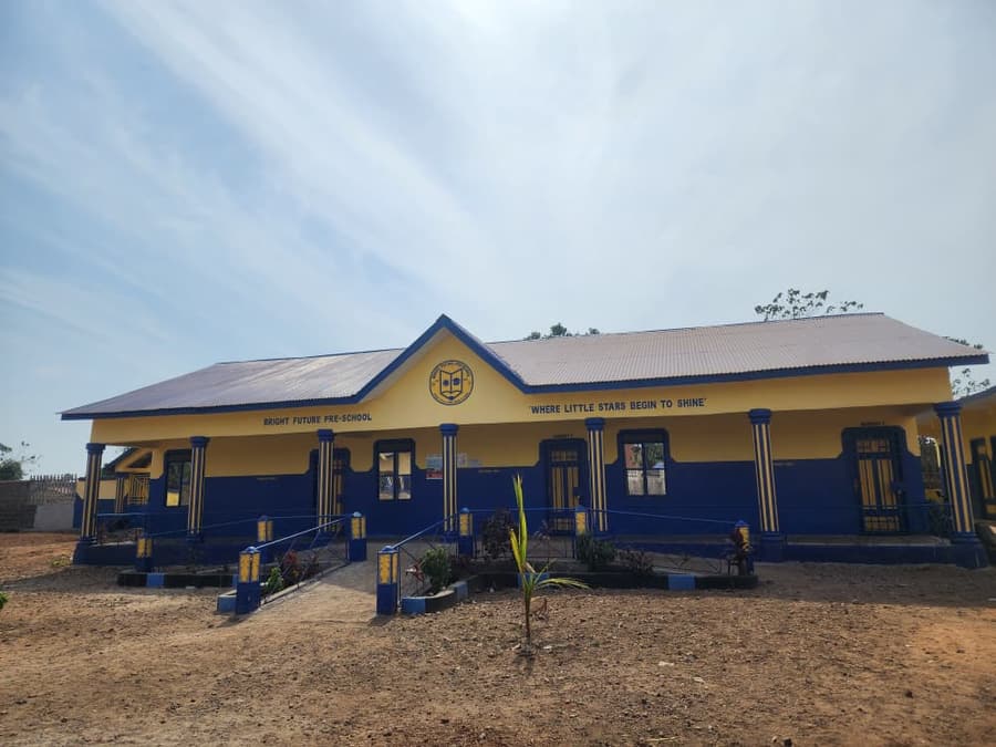 The blue and yellow Bright Future Pre-School building at Village of Hope, its veranda reached by a ramped and railed walkway, with the motto “Where little stars begin to shine” painted across the front.