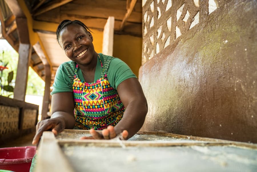 Amie Fullah smiles as she works a tray of soap in her production workshop.